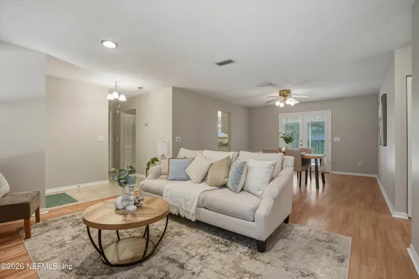 a living room with furniture a rug and a window