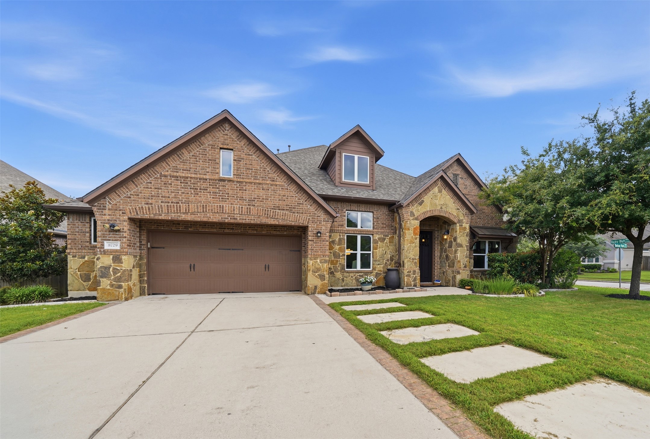 8729 Vantage Point Drive Austin, TX 78737 - Photo 4 of 33 A classic brick and stone facade welcomes with an arched entry and a two-car garage.