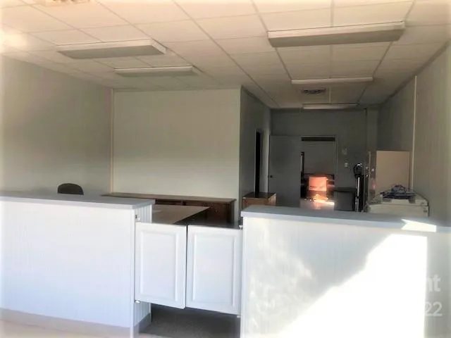 a dining room with furniture and a chandelier