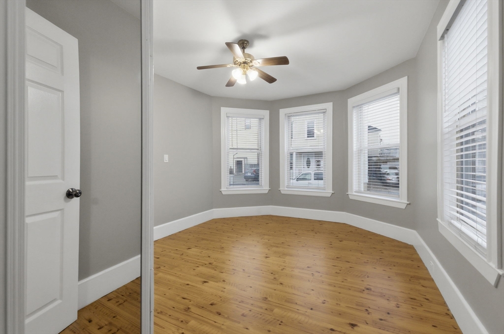 20 Bennett Street, Unit 1L Beverly, MA 01915 - Photo 12 of 22 a view of empty room with wooden floor and fan