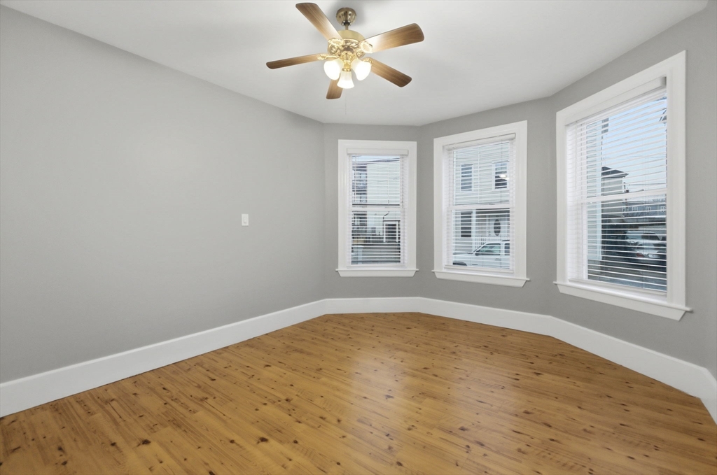 20 Bennett Street, Unit 1L Beverly, MA 01915 - Photo 14 of 22 a view of an empty room with window and a kitchen