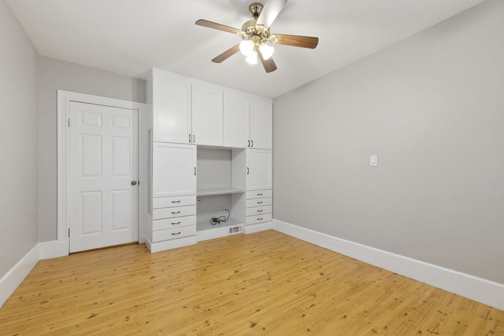 20 Bennett Street, Unit 1L Beverly, MA 01915 - Photo 15 of 22 a view of a room with cabinet and a ceiling fan
