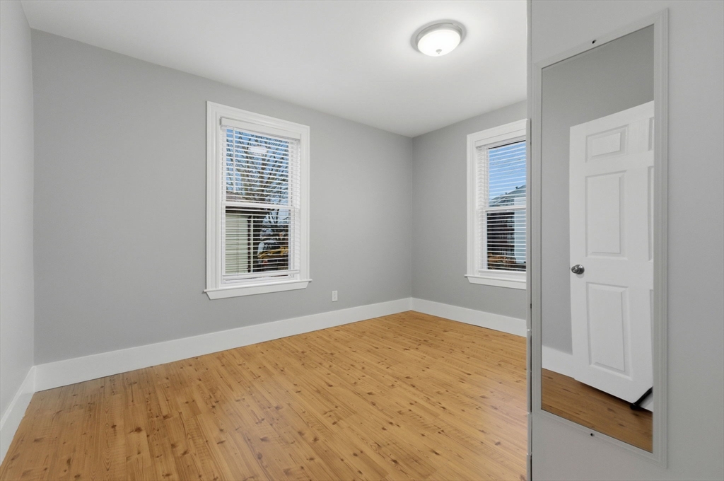 20 Bennett Street, Unit 1L Beverly, MA 01915 - Photo 16 of 22 a view of empty room with wooden floor and fan