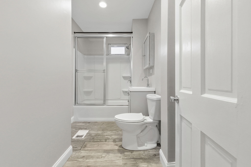 20 Bennett Street, Unit 1L Beverly, MA 01915 - Photo 18 of 22 a bathroom with a toilet and a shower
