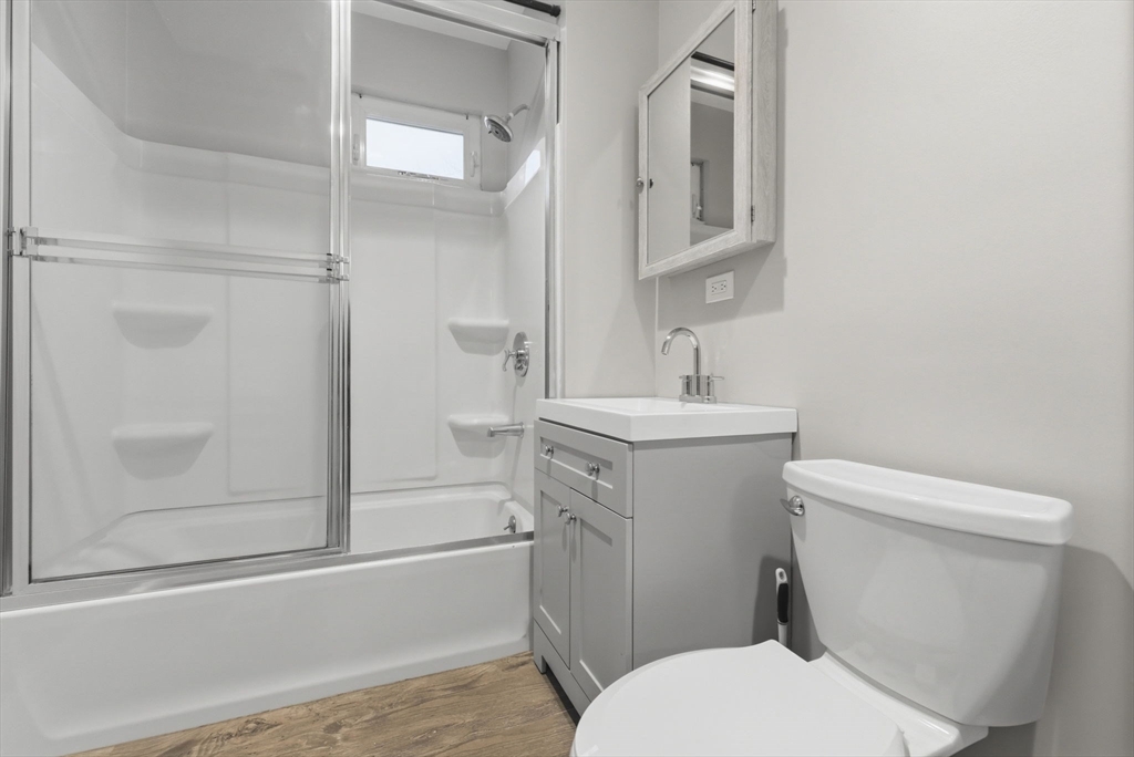20 Bennett Street, Unit 1L Beverly, MA 01915 - Photo 19 of 22 a bathroom with a sink a toilet and shower