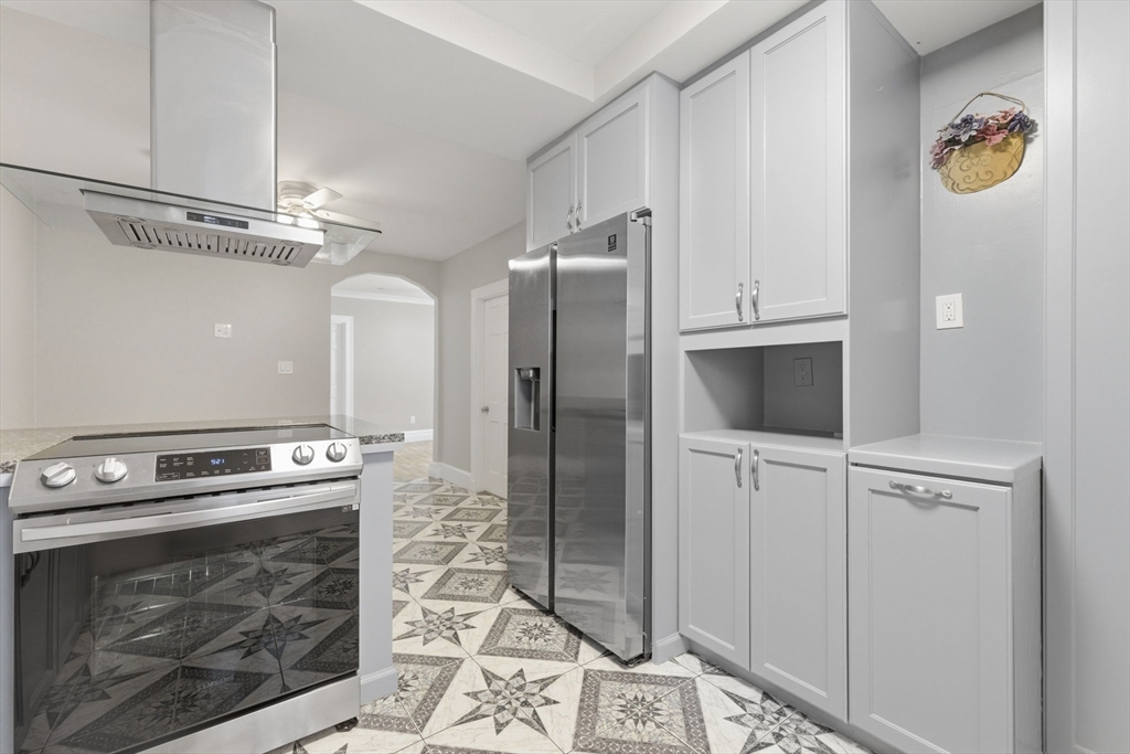 20 Bennett Street, Unit 1L Beverly, MA 01915 - Photo 21 of 22 a kitchen with stainless steel appliances granite countertop a stove a refrigerator and a microwave