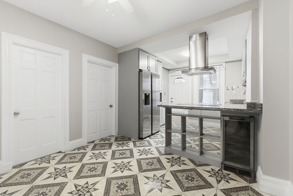 20 Bennett Street, Unit 1L Beverly, MA 01915 - Photo 5 of 22 a view of kitchen with granite countertop window and cabinetry