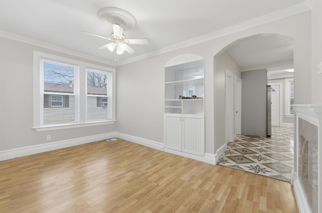 20 Bennett Street, Unit 1L Beverly, MA 01915 - Photo 6 of 22 a view of a livingroom with wooden floor and a ceiling fan