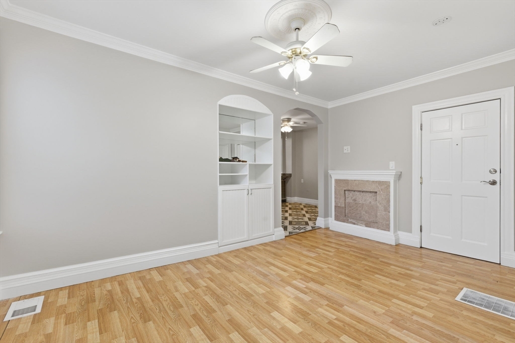 20 Bennett Street, Unit 1L Beverly, MA 01915 - Photo 7 of 22 wooden floor in an empty room with a chandelier fan