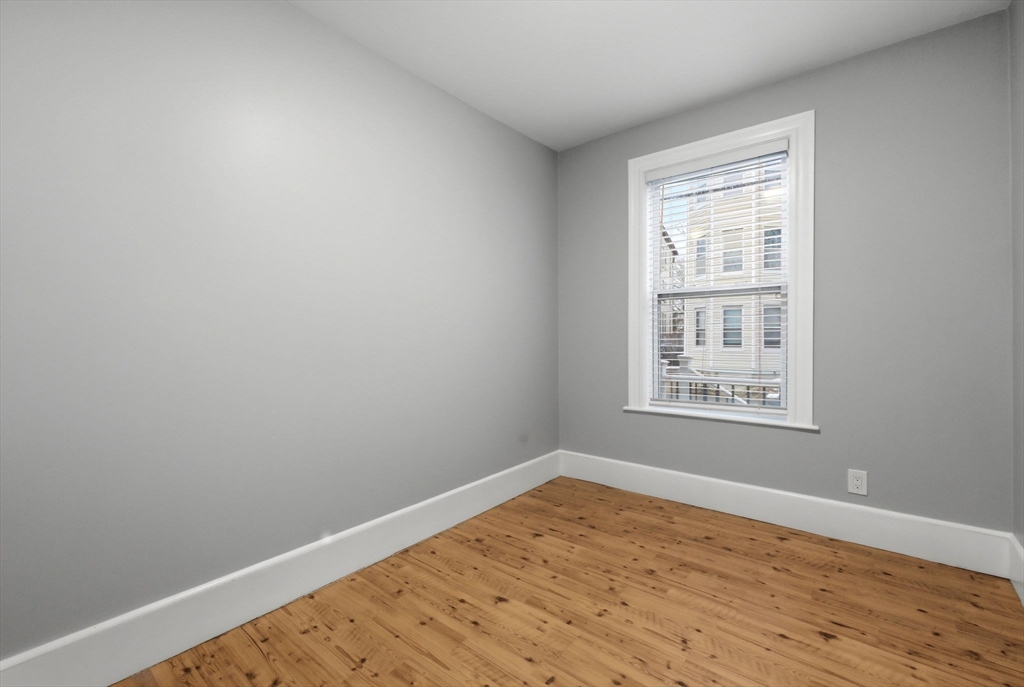 20 Bennett Street, Unit 1L Beverly, MA 01915 - Photo 10 of 22 wooden floor in an empty room with a window