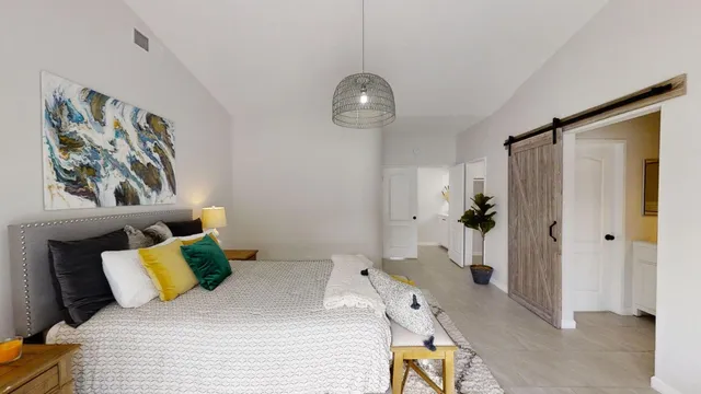 a bedroom with a bed and a chandelier