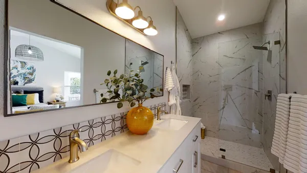 a bathroom with a sink a mirror and a shower