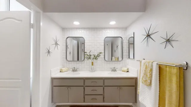 a bathroom with double vanity sinks and a mirror