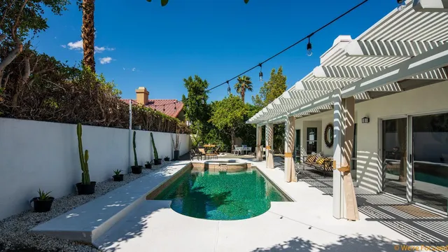a view of a patio with table and chairs with wooden fence and plants
