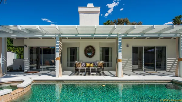 a view of a house with a yard balcony and sitting area