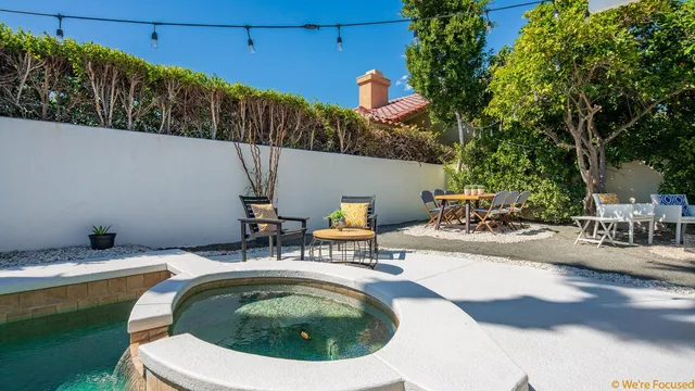 a small pool with table and chairs