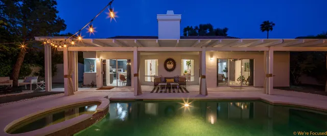 a view of a swimming pool with a table and chairs