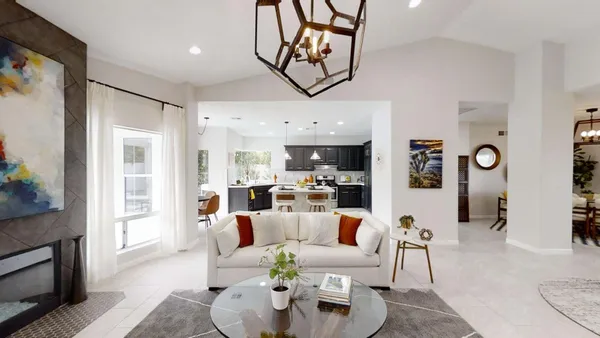 a living room with furniture and kitchen view