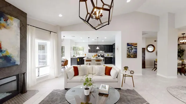 a living room with furniture and kitchen view