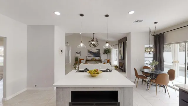 a kitchen with a table and chairs