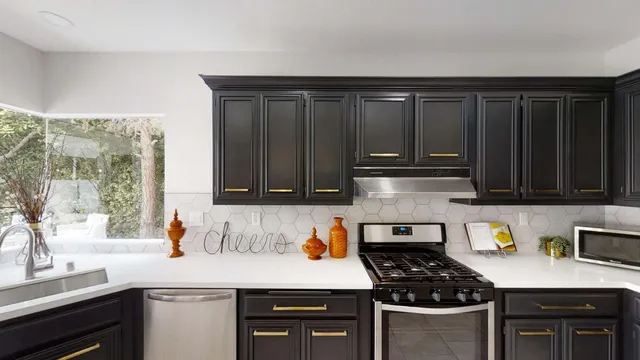 a kitchen with granite countertop a stove a sink and wooden cabinets