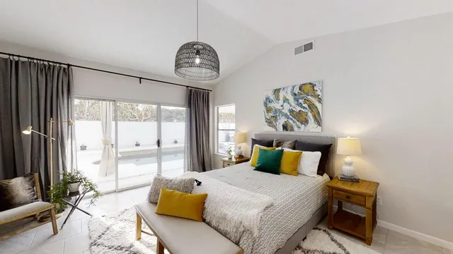a bedroom with a bed and a chandelier