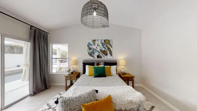 a bedroom with a bed and a window