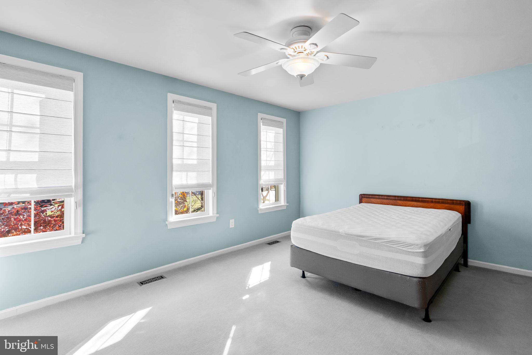12633 English Orchard Court Silver Spring, MD 20906 - Photo 21 of 45 a bed sitting in a bedroom next to a window