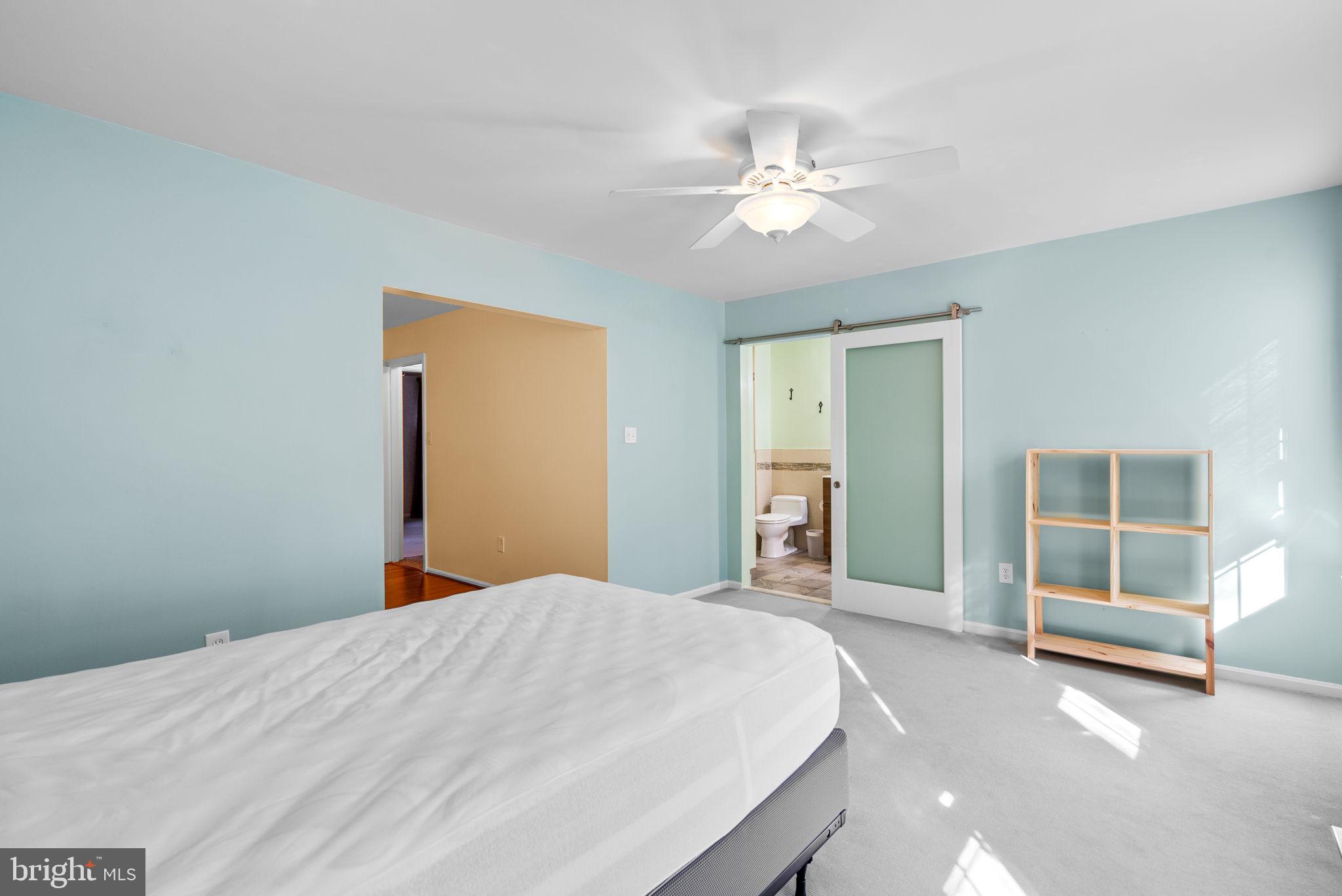 12633 English Orchard Court Silver Spring, MD 20906 - Photo 22 of 45 a bedroom with a large bed and a chandelier