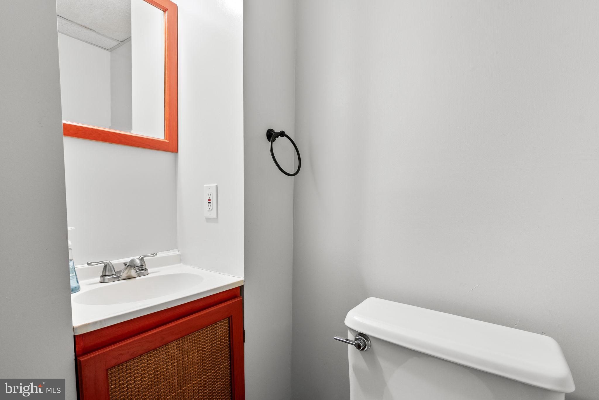 12633 English Orchard Court Silver Spring, MD 20906 - Photo 29 of 45 a bathroom with a toilet sink and mirror