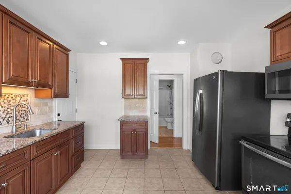 a kitchen with granite countertop a sink and cabinets