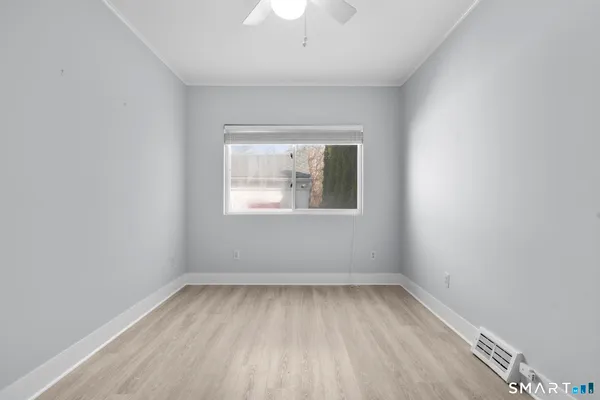 wooden floor in an empty room with a window