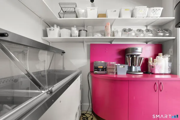 a kitchen with granite countertop lots of clutter and cabinets