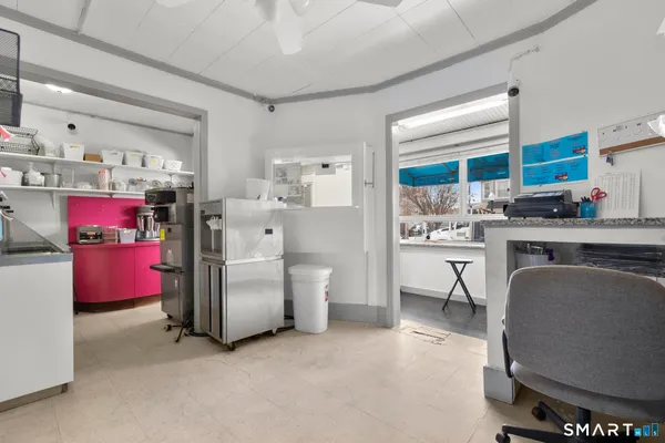 a room with stainless steel appliances a refrigerator and cabinets