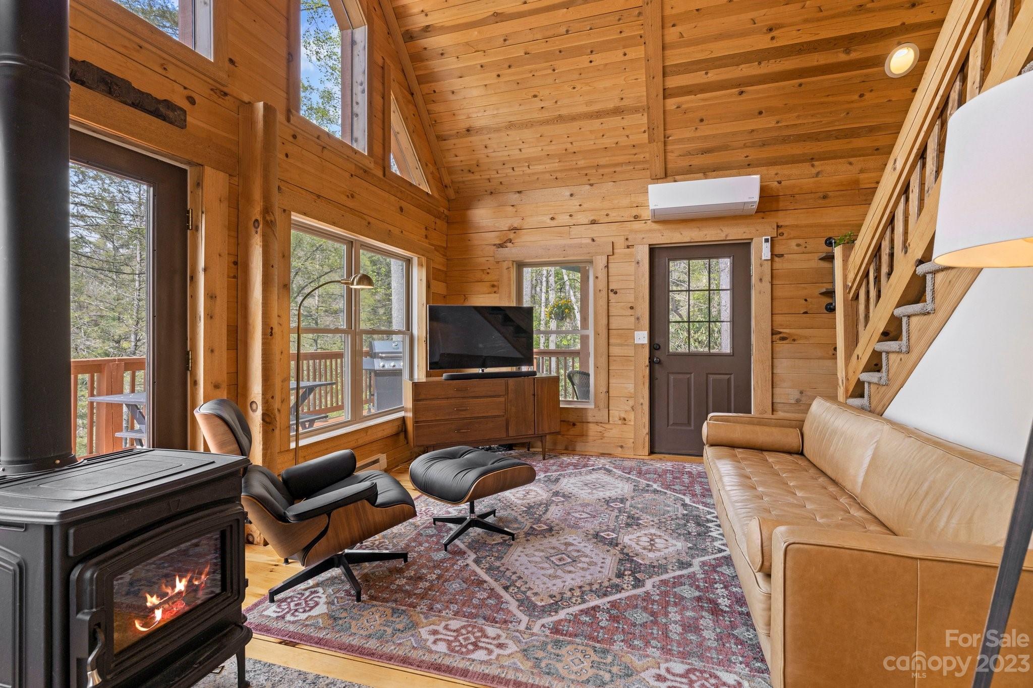 2023 Turnpike Road Marshall, NC 28753 - Photo 13 of 47 a living room with furniture a flat screen tv and a fireplace