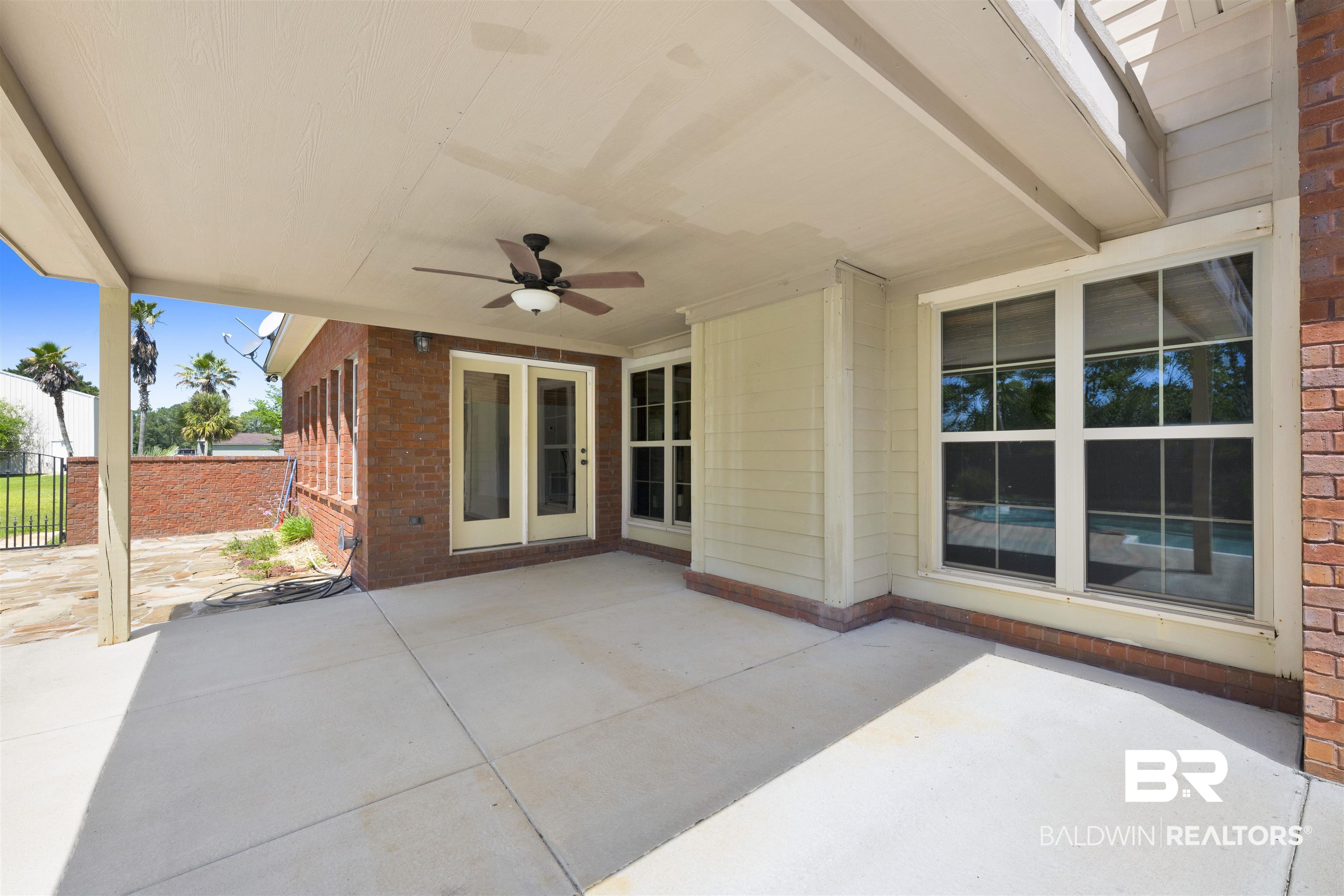 12944 Anna's Way Stapleton, AL 36578 - Photo 29 of 64 Covered patio featuring a ceiling fan with light fixture, concrete flooring, and direct access to interior spaces through French doors