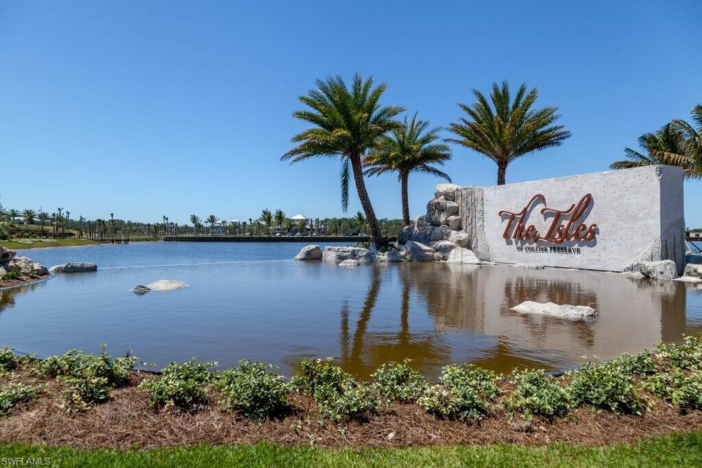 8914 Gustavia Court Naples, FL 34113 - Photo 14 of 23 a view of a lake with a building in the background