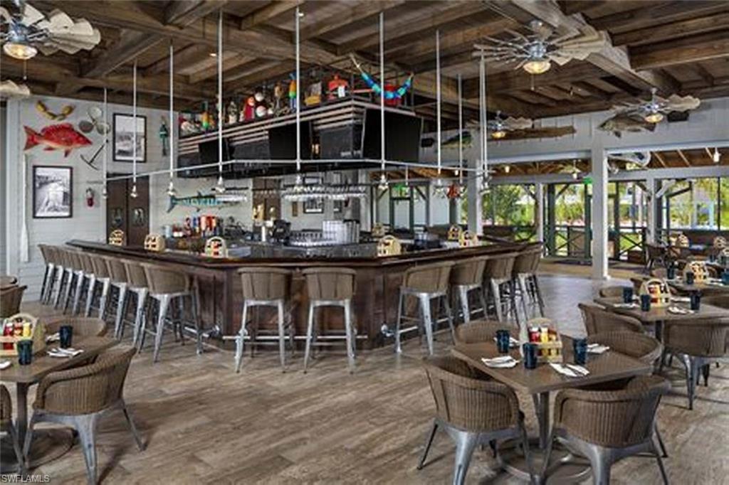 8914 Gustavia Court Naples, FL 34113 - Photo 22 of 23 a view of a chairs and table in a room