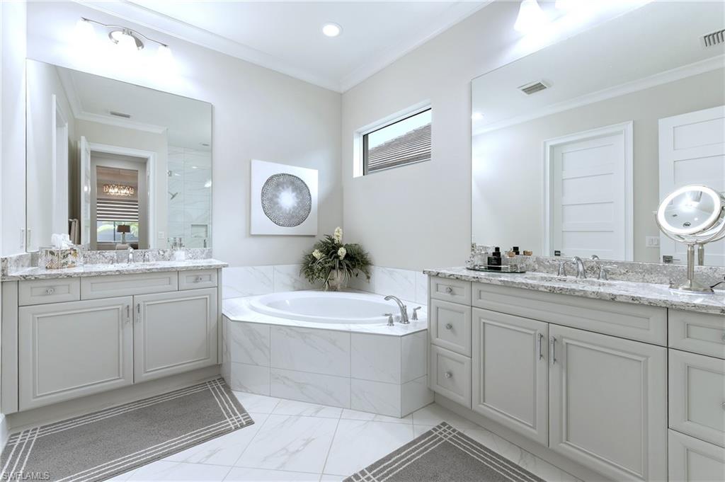 8914 Gustavia Court Naples, FL 34113 - Photo 6 of 23 a bathroom with a double vanity sink mirror and bathtub
