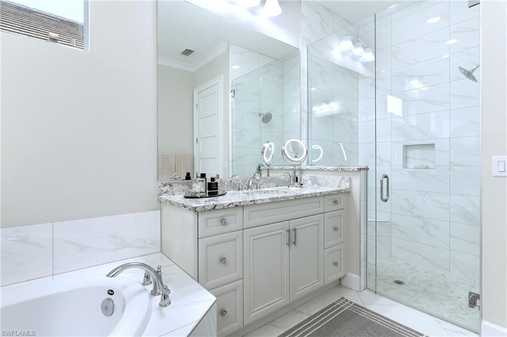 8914 Gustavia Court Naples, FL 34113 - Photo 7 of 23 a bathroom with a granite countertop sink mirror and shower