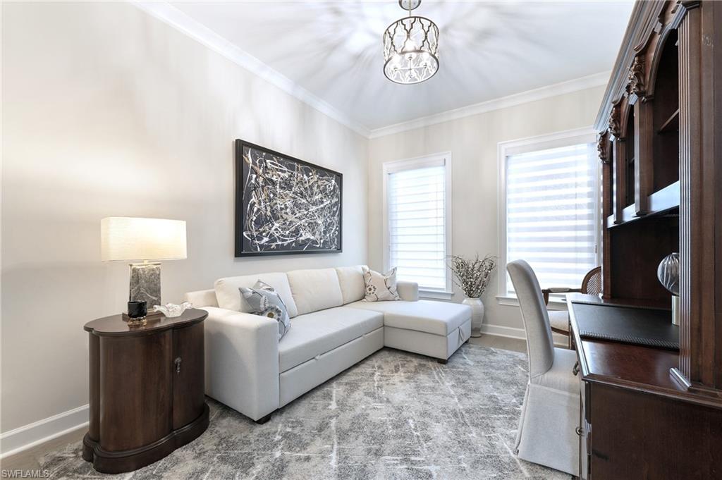 8914 Gustavia Court Naples, FL 34113 - Photo 9 of 23 a living room with furniture a window and a flat screen tv