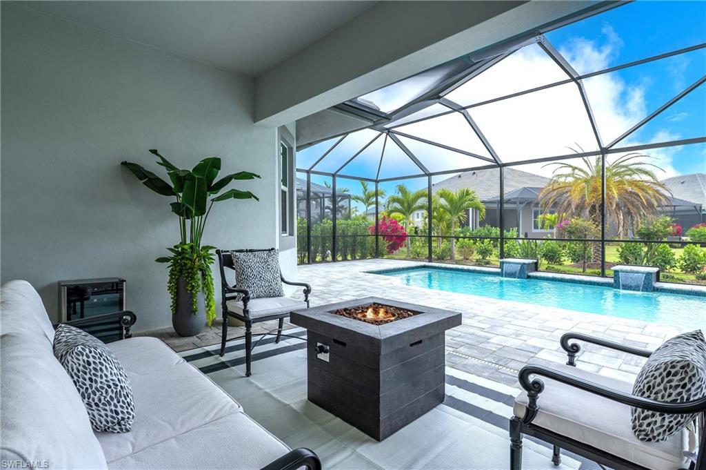 8914 Gustavia Court Naples, FL 34113 - Photo 10 of 23 a living room with furniture a couch and two potted plants