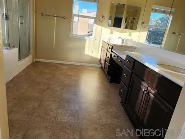 a bathroom with double vanity and a sink