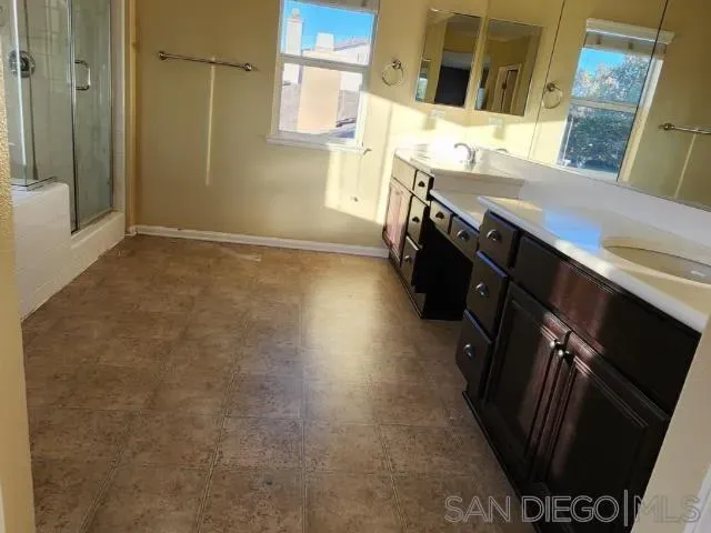 a bathroom with double vanity and a sink