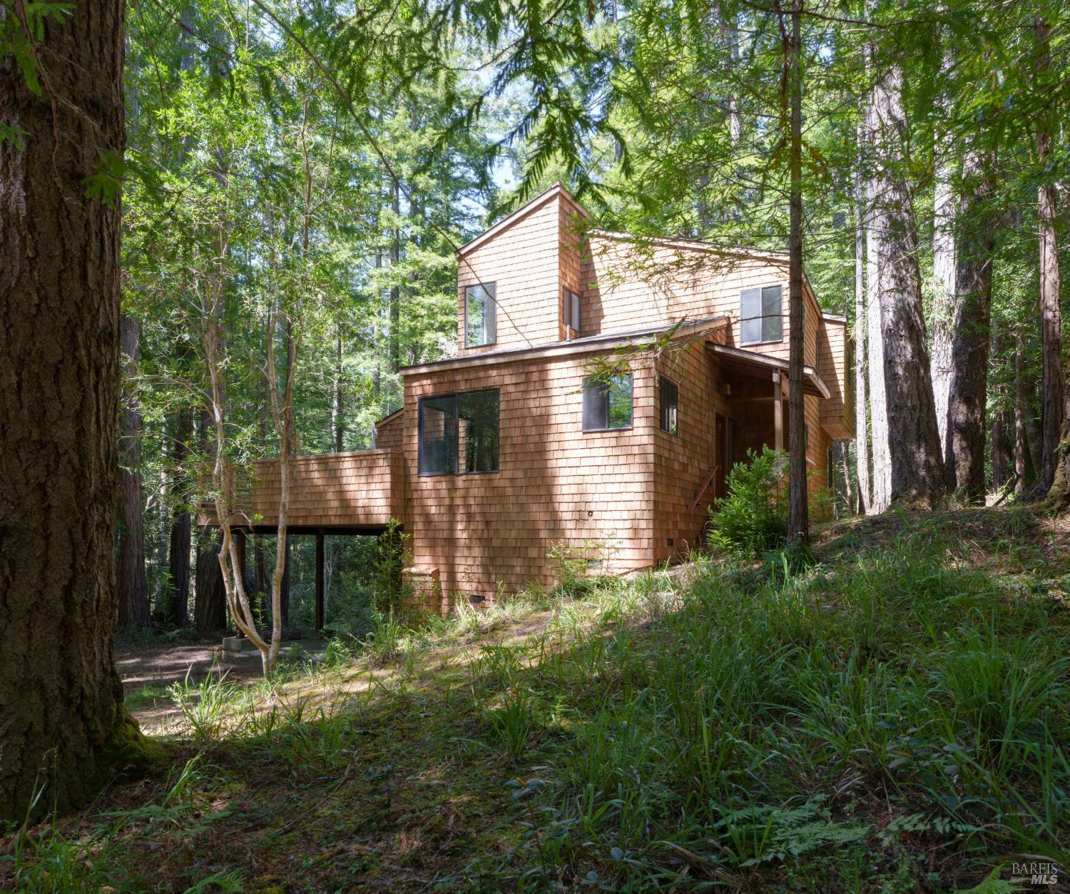 355 Chinquapin Lane The Sea Ranch, CA 95497 - Photo 2 of 31 a front view of a house with a yard table and chairs