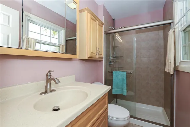 a bathroom with a sink toilet and shower