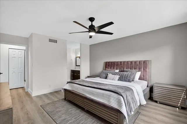 a bedroom with a bed and a ceiling fan