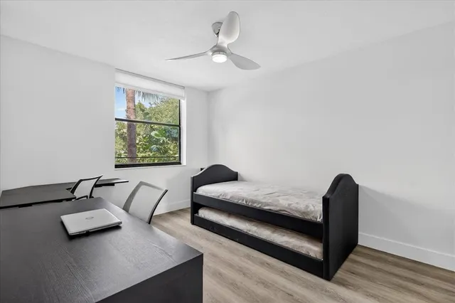 a bedroom with furniture and a window