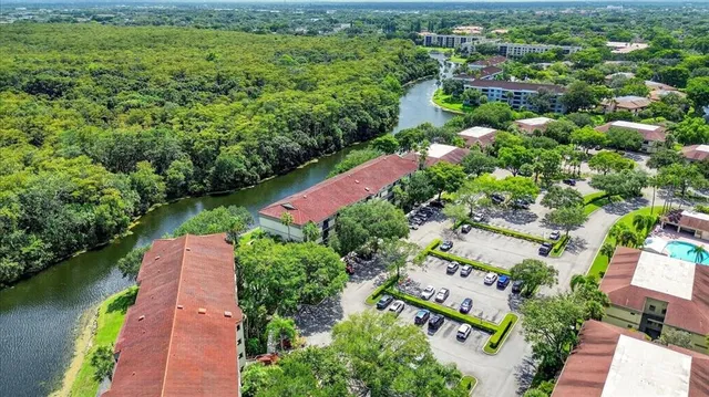 an aerial view of residential houses with outdoor space and river