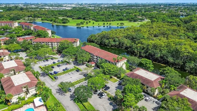 an aerial view of a houses with a lush green hillside